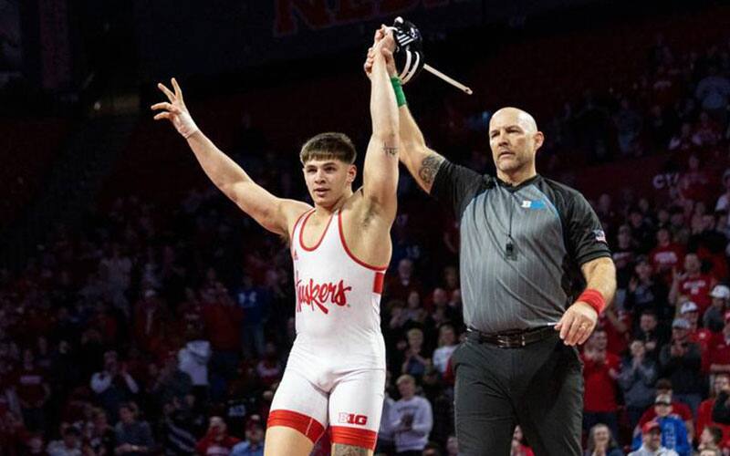 Lenny Pinto (Nebraska) with arm raised in victory.