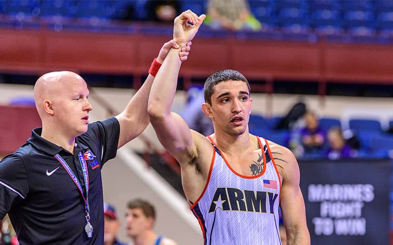 Alejandro Sancho (U.S. Army) with arm raised in victory.