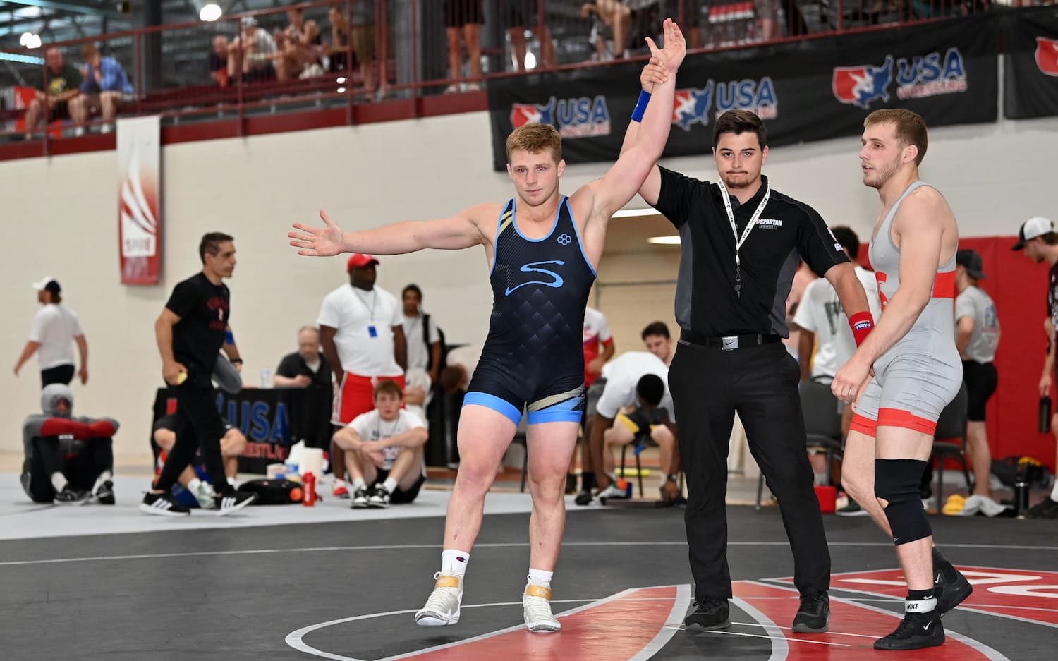 Payton Jacobson gets his hand raised after defeating Caleb Fish in the U23 Greco-Roman Nationals Finals