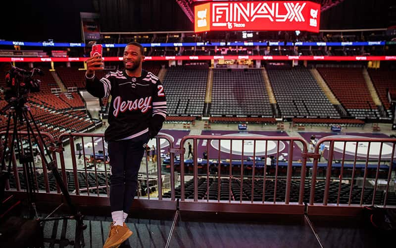 Jordan Burroughs takes a selfie wearing a custom New Jersey Devils hockey jersey in the Prudential Center prior to Final X.