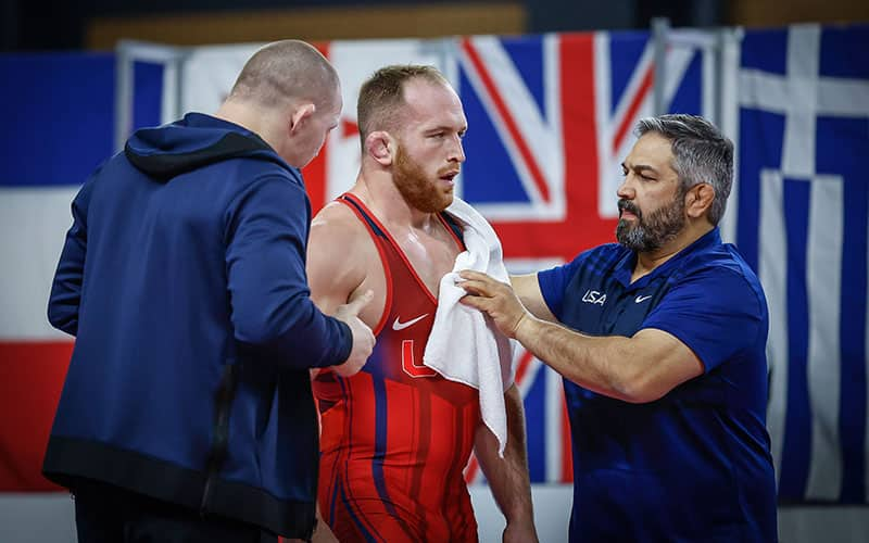 Coaches Jake Varner and Bill Zadick work with Kyle Snyder during the break of a match at the Dan Kolov/Nikola Petrov International.