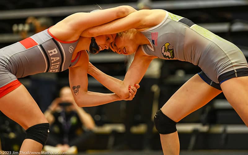 Up close picture of two women wrestlers tying up at the 2023 NAIA Nationals