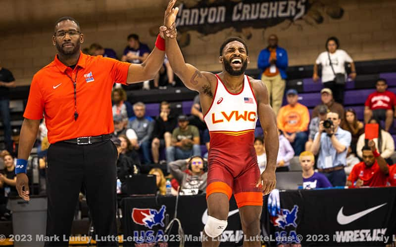 Nahshon Garrett celebrates as his arm is raised in victory at the World Team Trials Challenge Tournament.