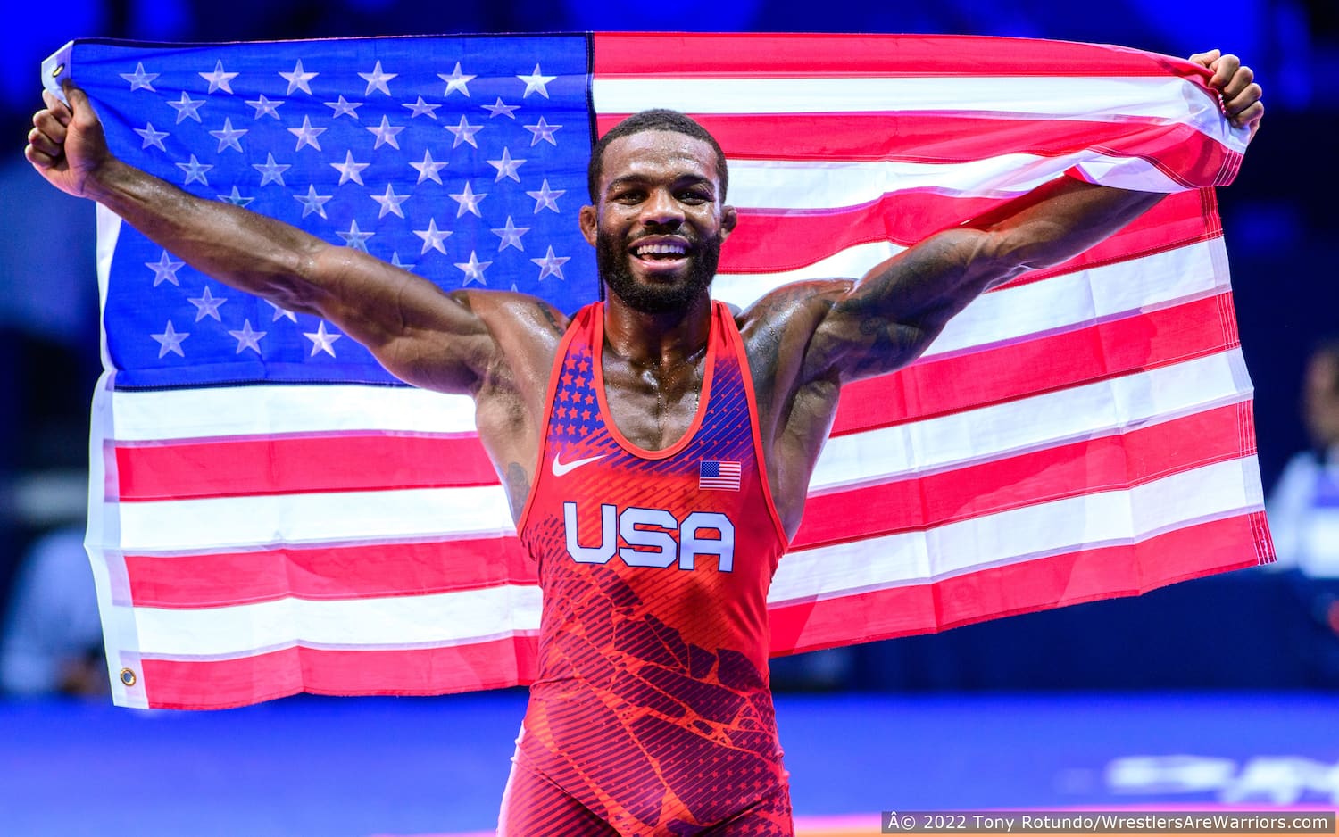 Jordan Burroughs holding the U.S. flag at the 2022 World Championships