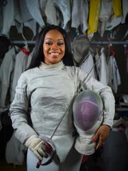 Kamali Thompson stands with her saber and mask.