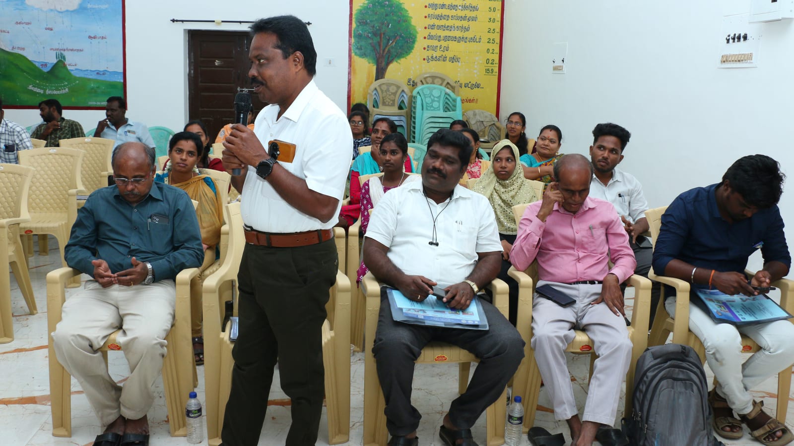 A facilitator addressing participants during a climate-change adaptation training workshop