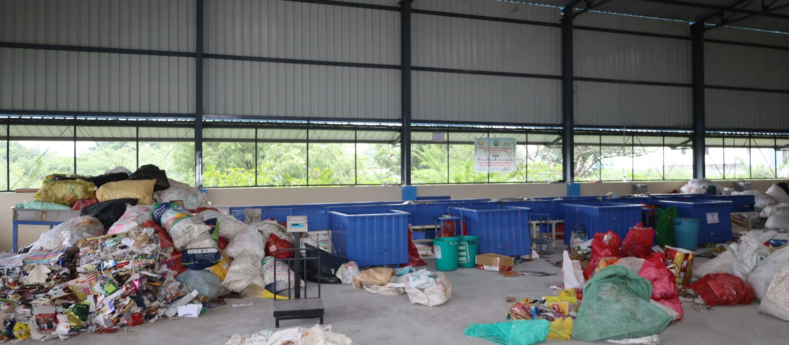 Sorting bays and baled waste inside the Material Recovery Facility shed