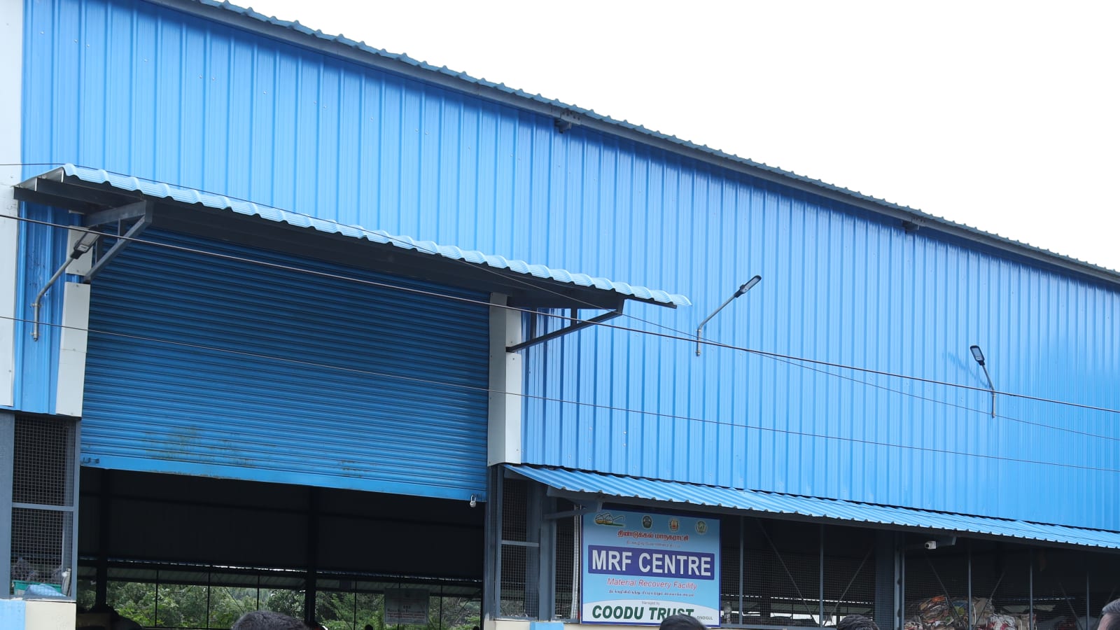 The blue-clad Material Recovery Facility shed with its MRF Centre and Coodu Trust signboard