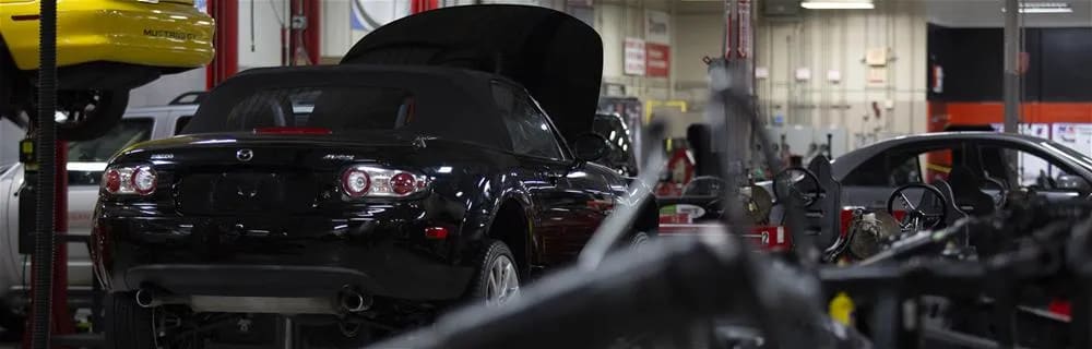 Automobiles sitting in a garage.