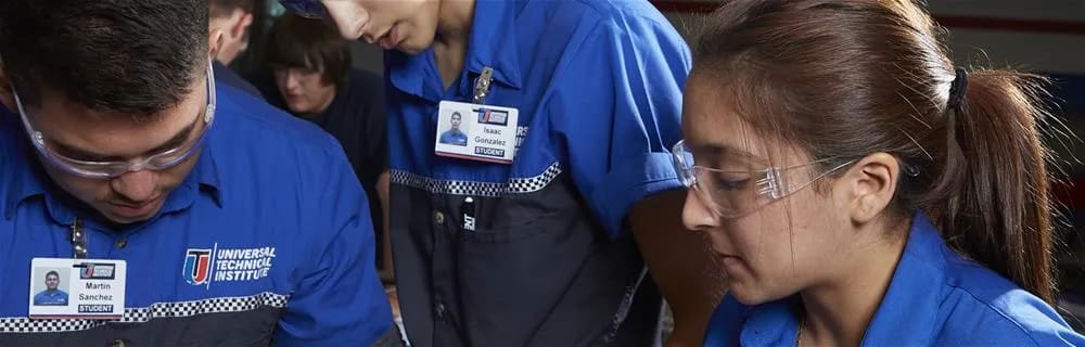 Students working on a car part.