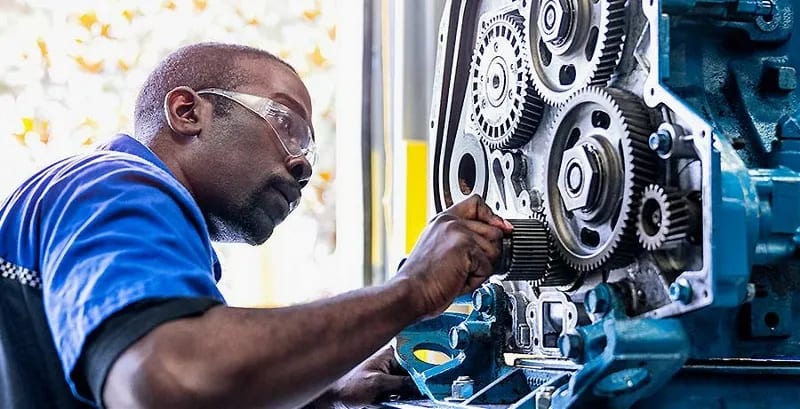 Diesel student checks an engine at a UTI lab.