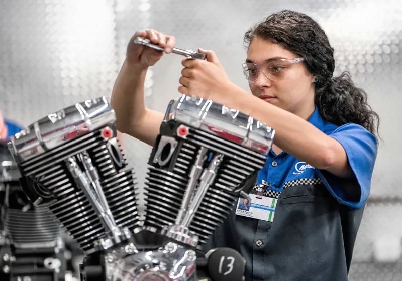 A student works on a Harley-Davidson® motorcycle engine in an MMI lab.