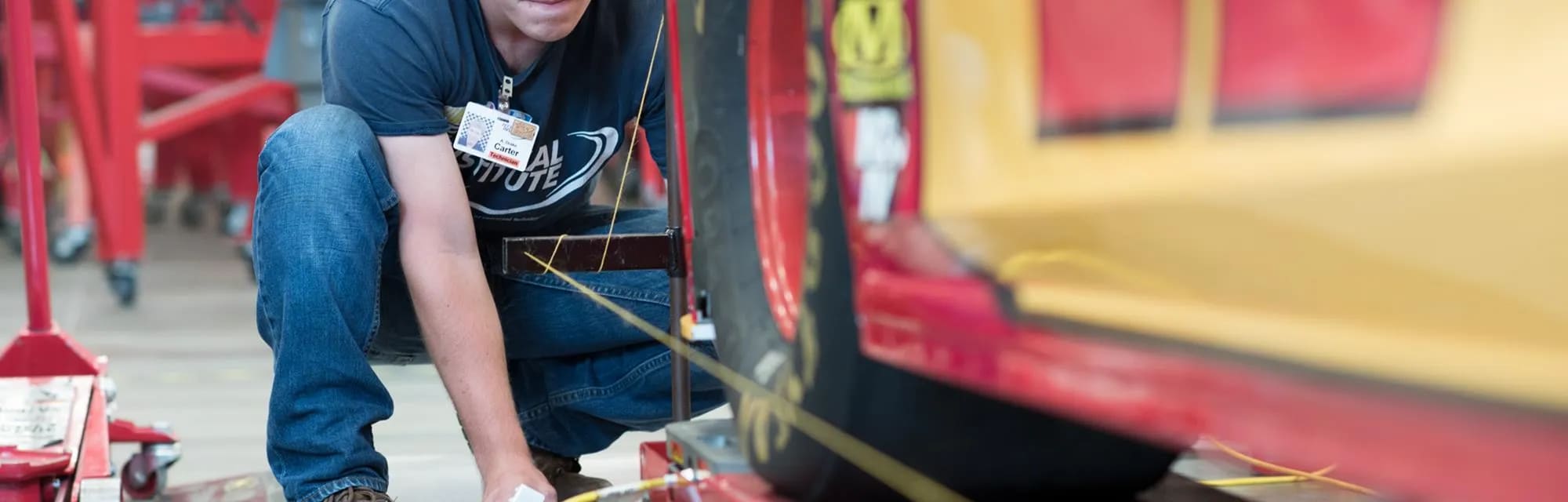 Student inspecting a NASCAR automobile