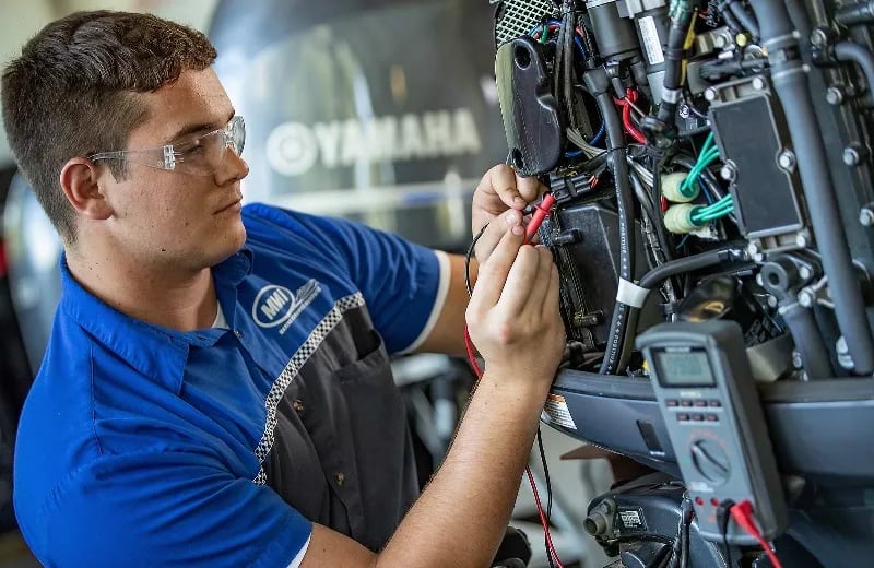 A student works on a motor in an MMI lab.