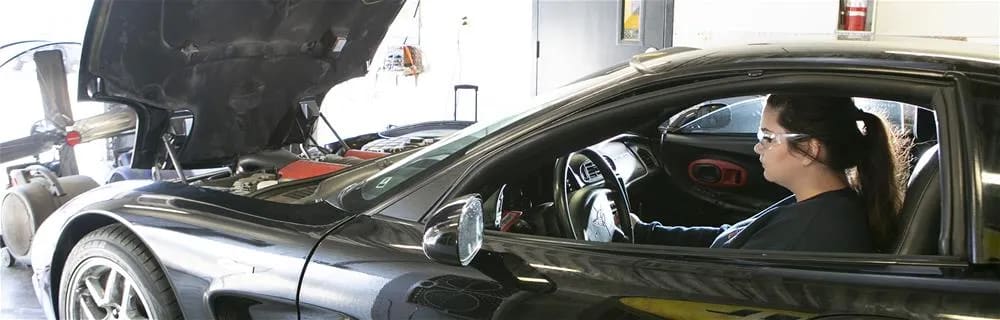 Female student testing performance on a car