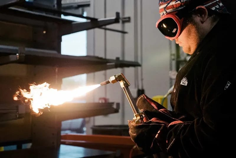 A student works on a weld at a UTI lab.