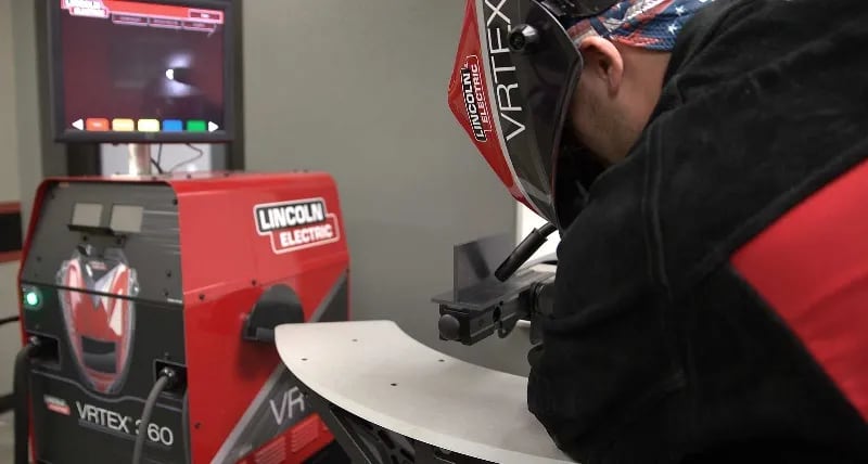 A welding student works on a project in a UTI lab.