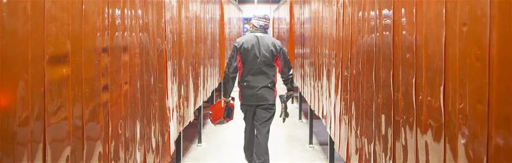 Man walking in locker room hallway