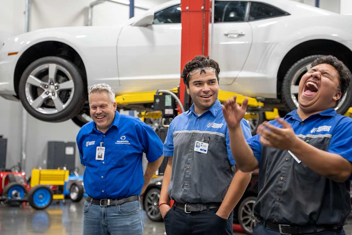 Students laughing together on UTI campus, preferably a group of diverse students