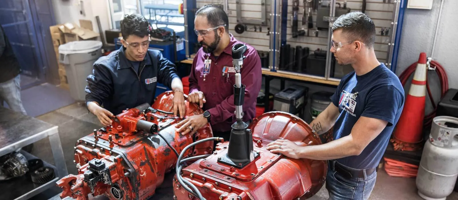 Instructor-and-UTI-Diesel-Program-students-working-together-in-a-lab