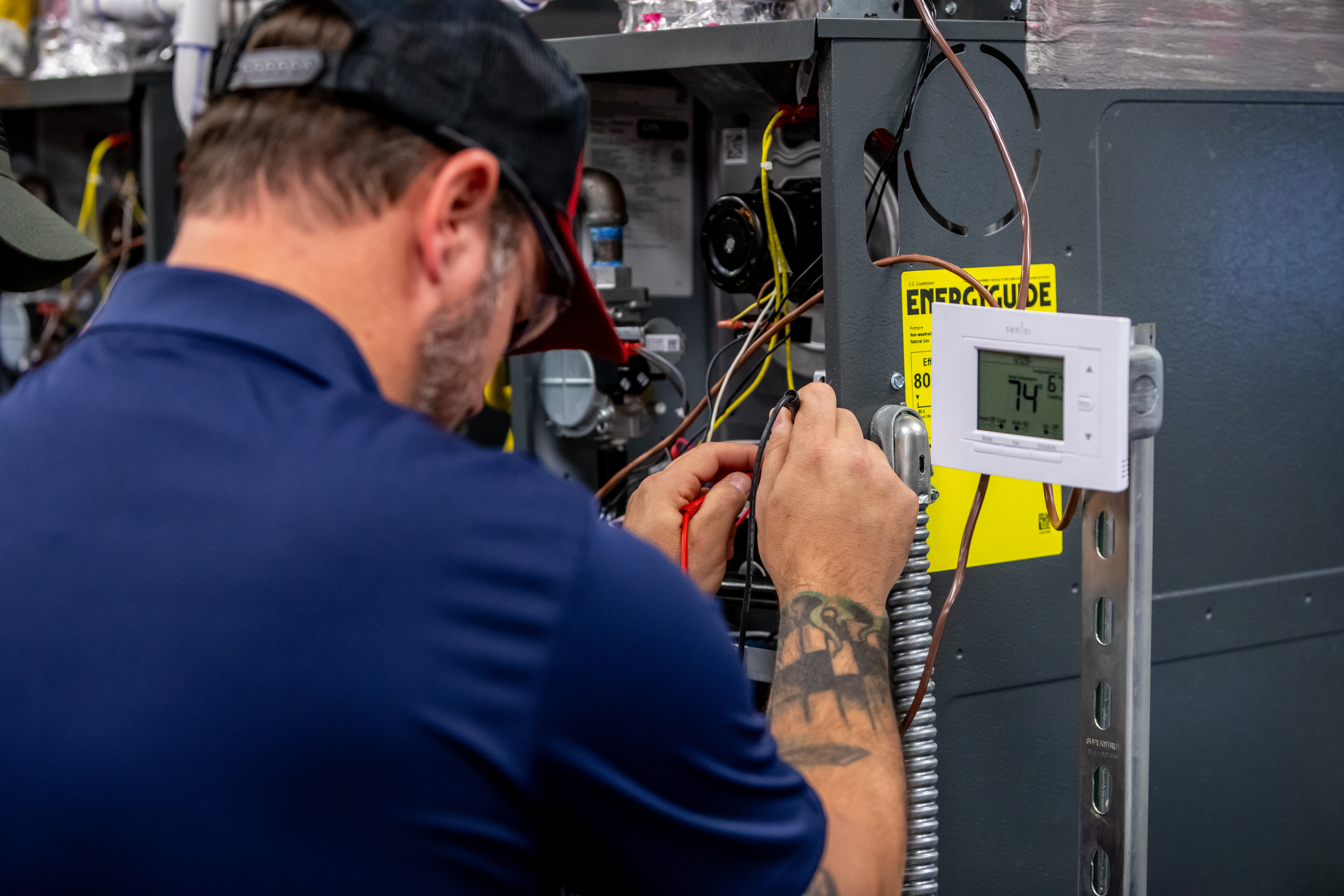 HVAC Training Program - Technician working on HVAC equipment.