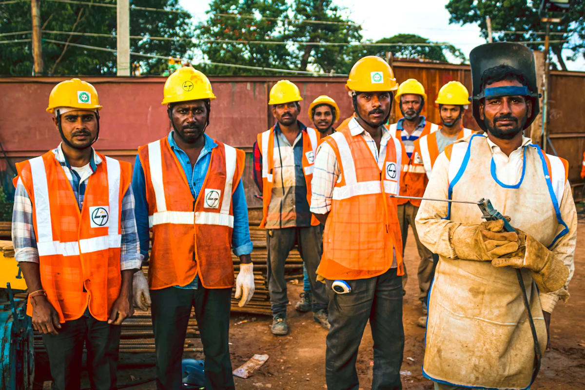 Site workers in safety helmets and vests