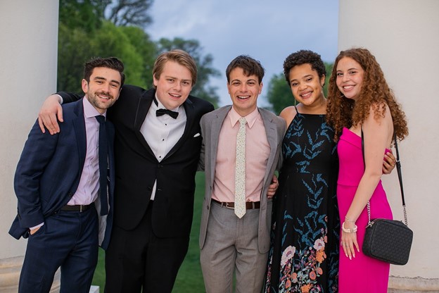 Students in formal attire smiling