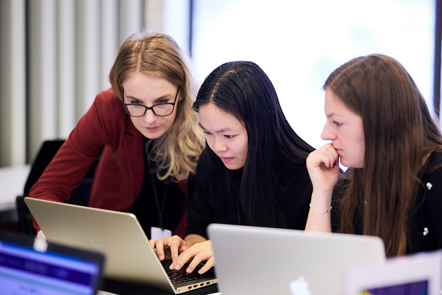 Students sitting around a laptop