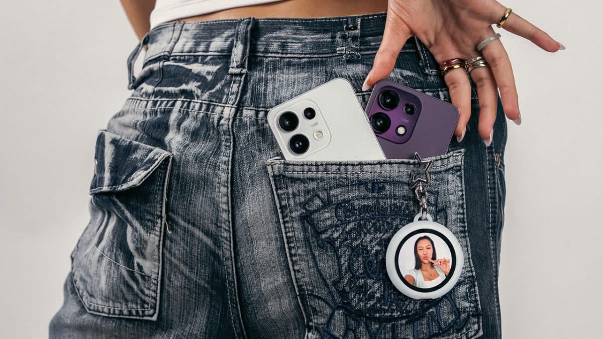 OPPO Reno16 in white and purple tucked into a back jeans pocket with an OPPO Bubble keyring, launched in NZ
