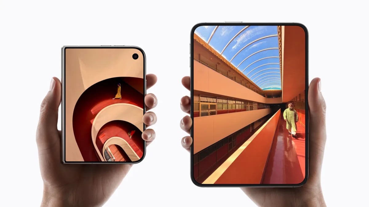 The iPhone Duo held folded in one hand and fully open in another, showing the outer and inner displays