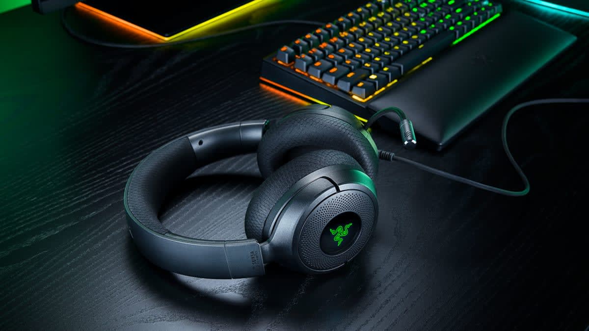 Close-up of the wired Razer Kraken V4 X Sensa HD Haptics headset with its cable plugged in beside a keyboard