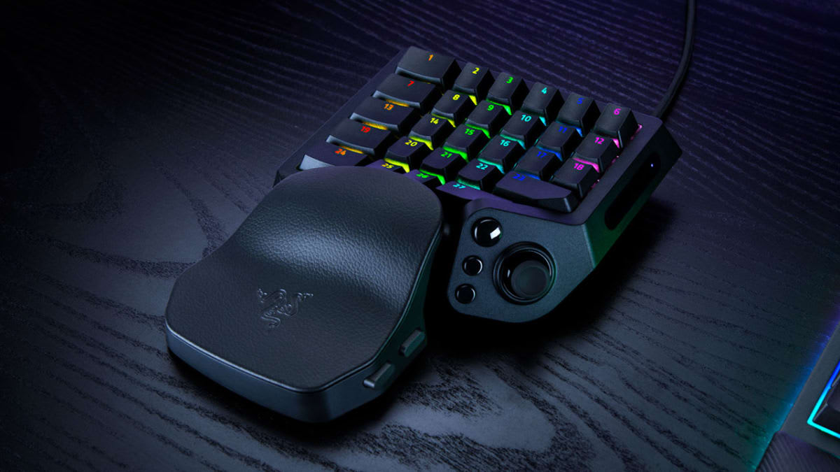 Razer Tartarus V2 Pro keypad on a dark desk with its RGB key lighting on