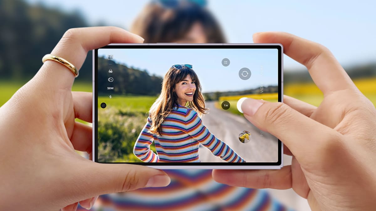 Galaxy Z Fold8 held in landscape with the camera app open, framing a 50MP shot of a woman on a country road