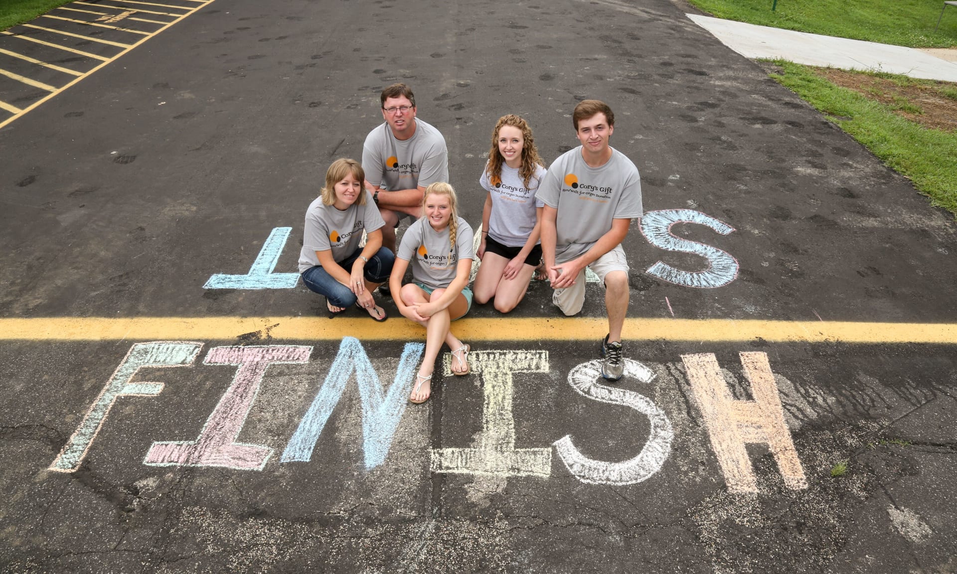 Adams 46024-2386.jpg A family at the chalk-drawn start/finish line of a run-walk event.