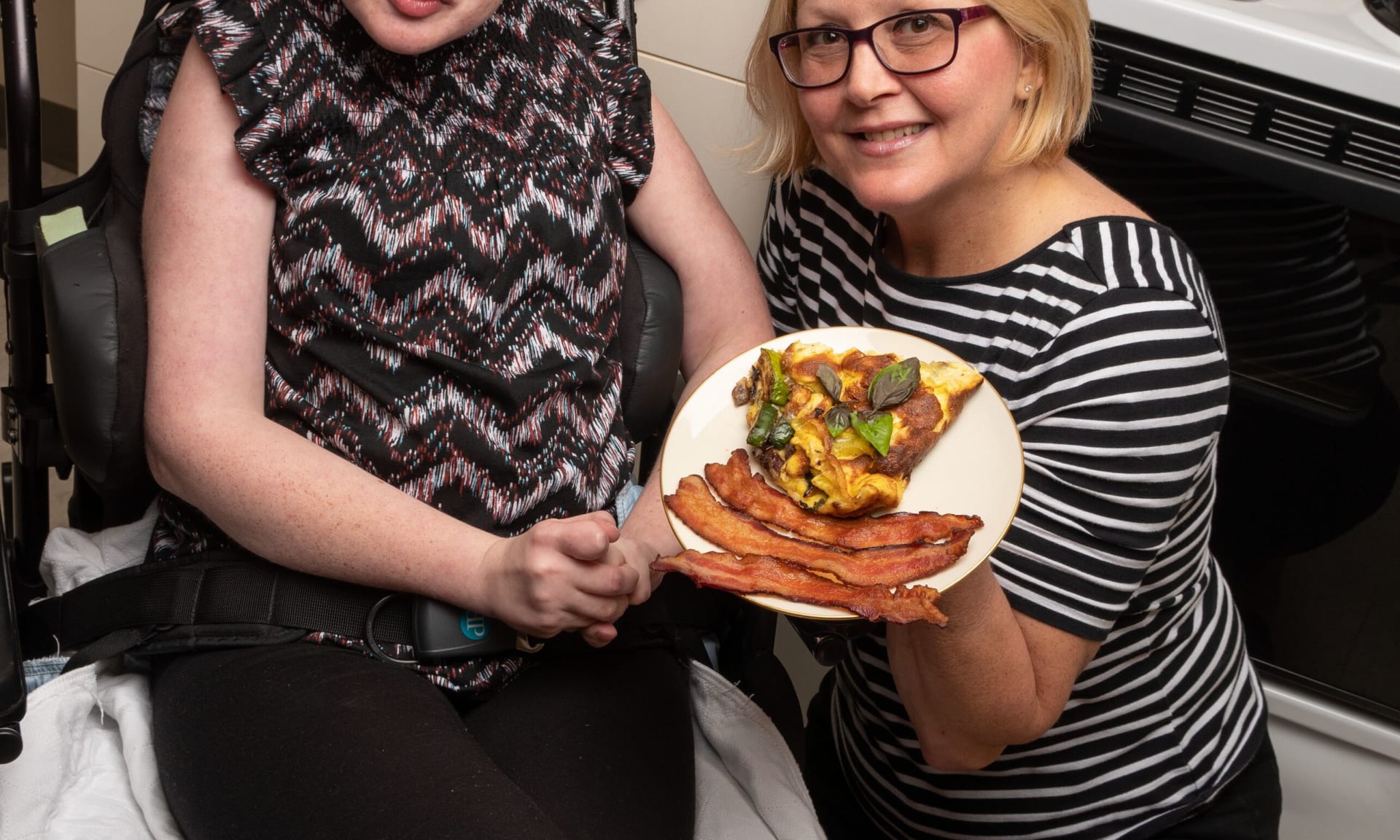 Keto Diet 223737-1766.jpg Girl and mother holding a plate of food.