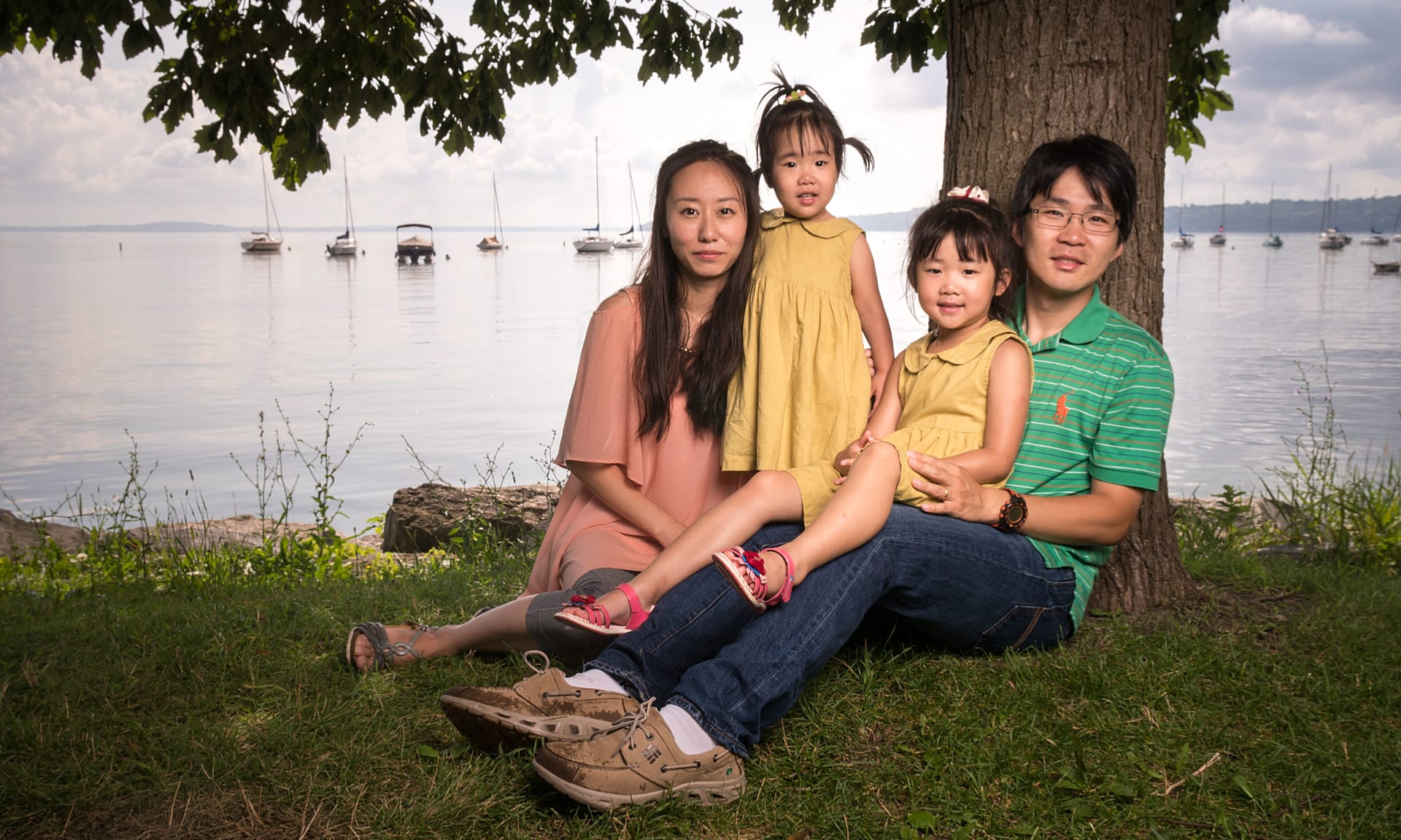 Meiyee 25694-0614.jpg A family of four sitting near a tree on a lakeshore on a beautiful night