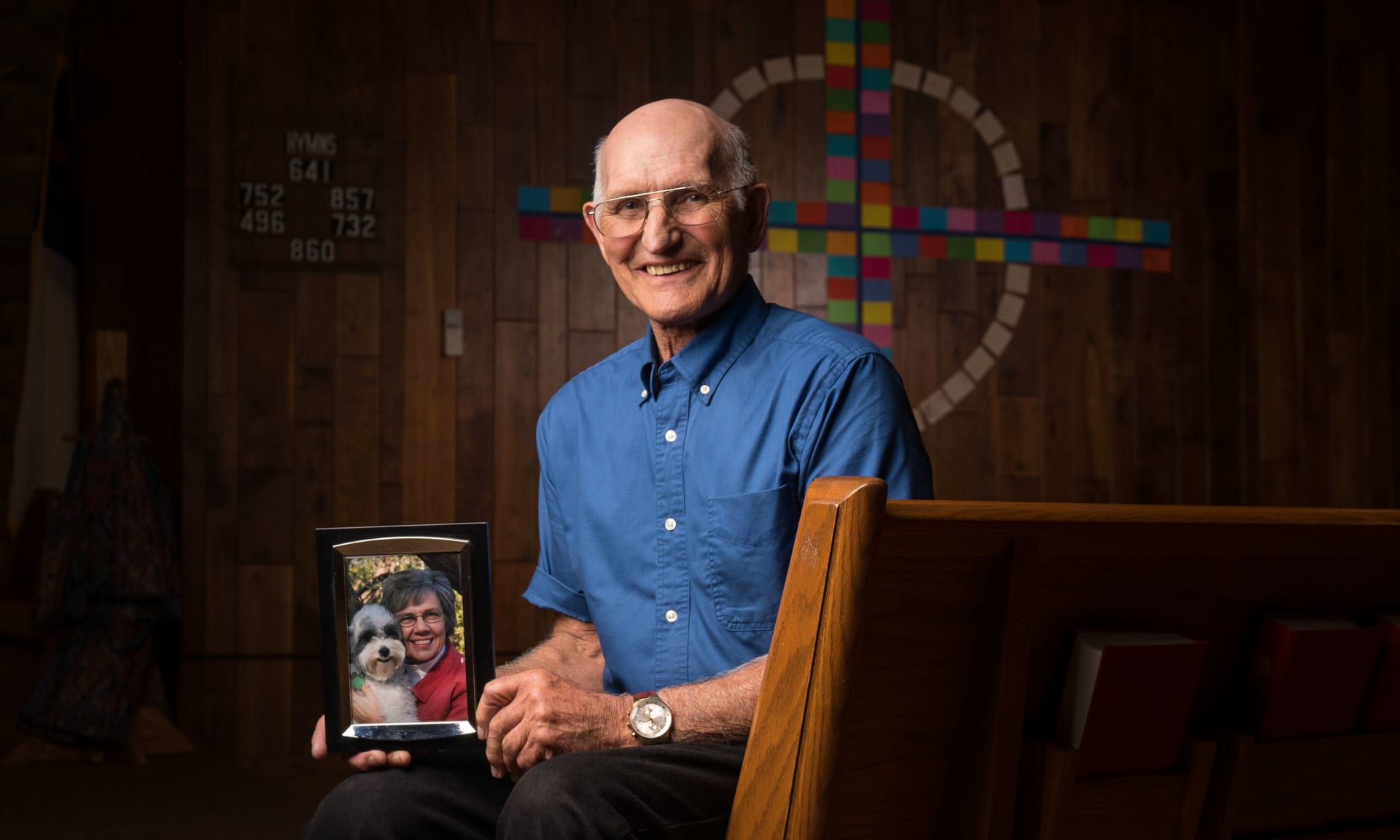Wright 62628-6837.jpg Man smiling and holding a picture of his wife.