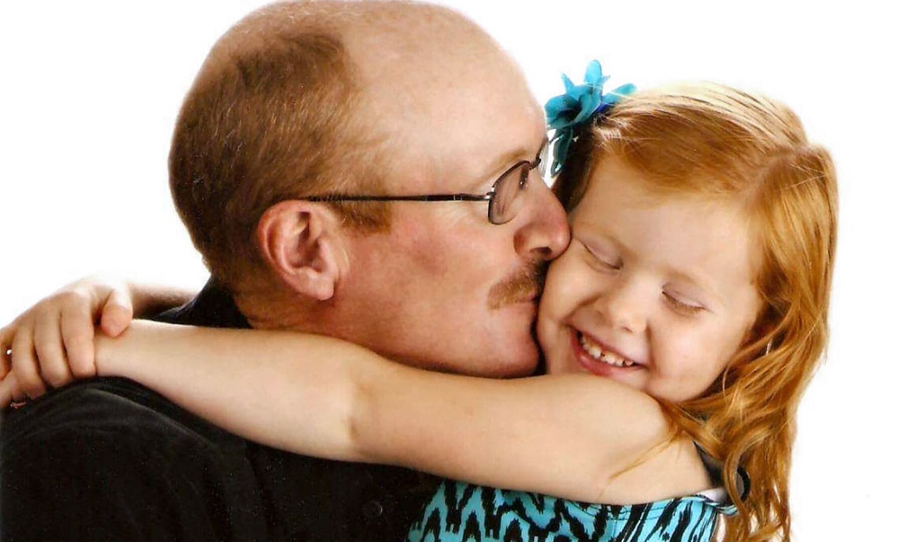 Pedretti 361256-1127.jpg A father gives his daughter a kiss.