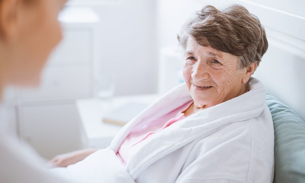 covidcancercaregiving Patient in bed with caregiver