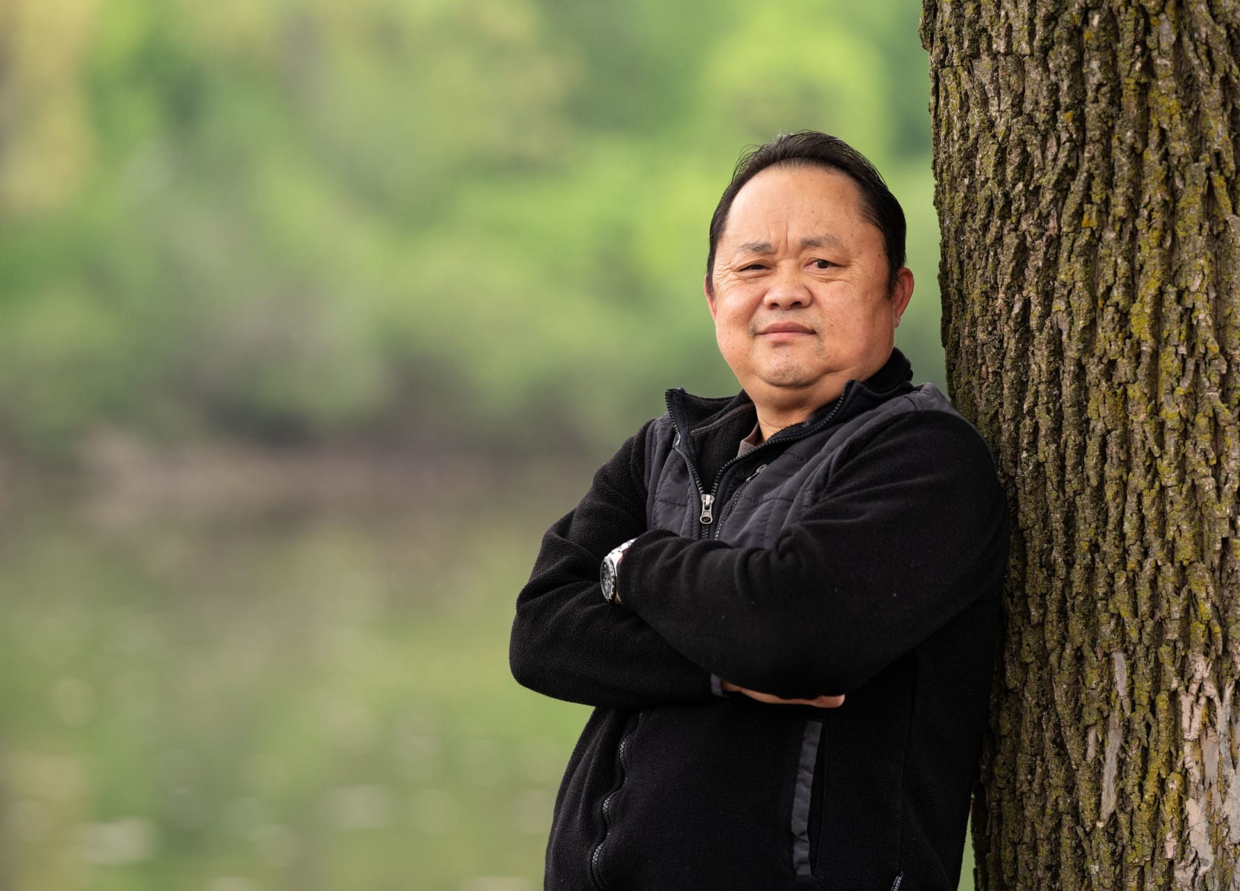 Chue Yang 514764-3459.jpg Man leaning against tree.
