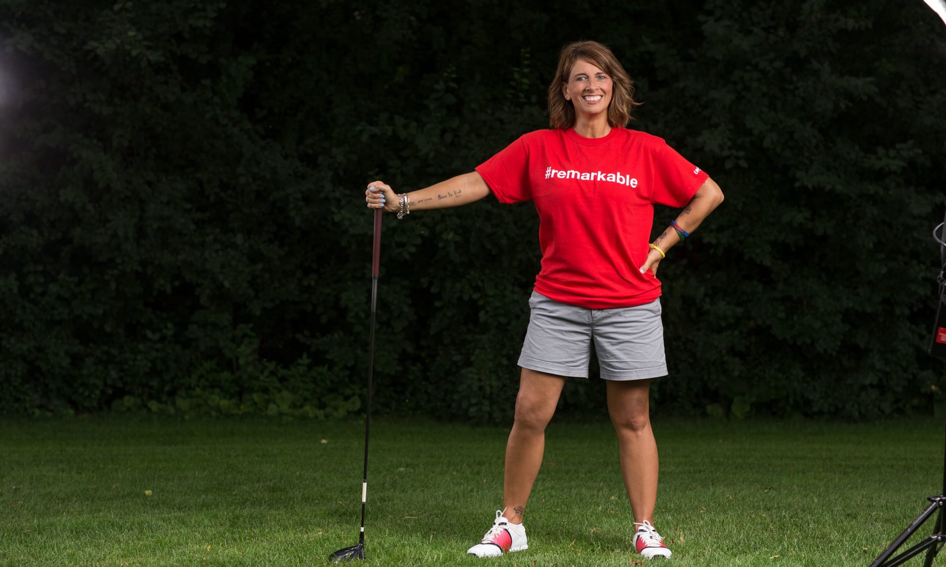 Lyons 142717-1104.jpg A woman wearing a t-shirt that says Remarkable and holding a golf club