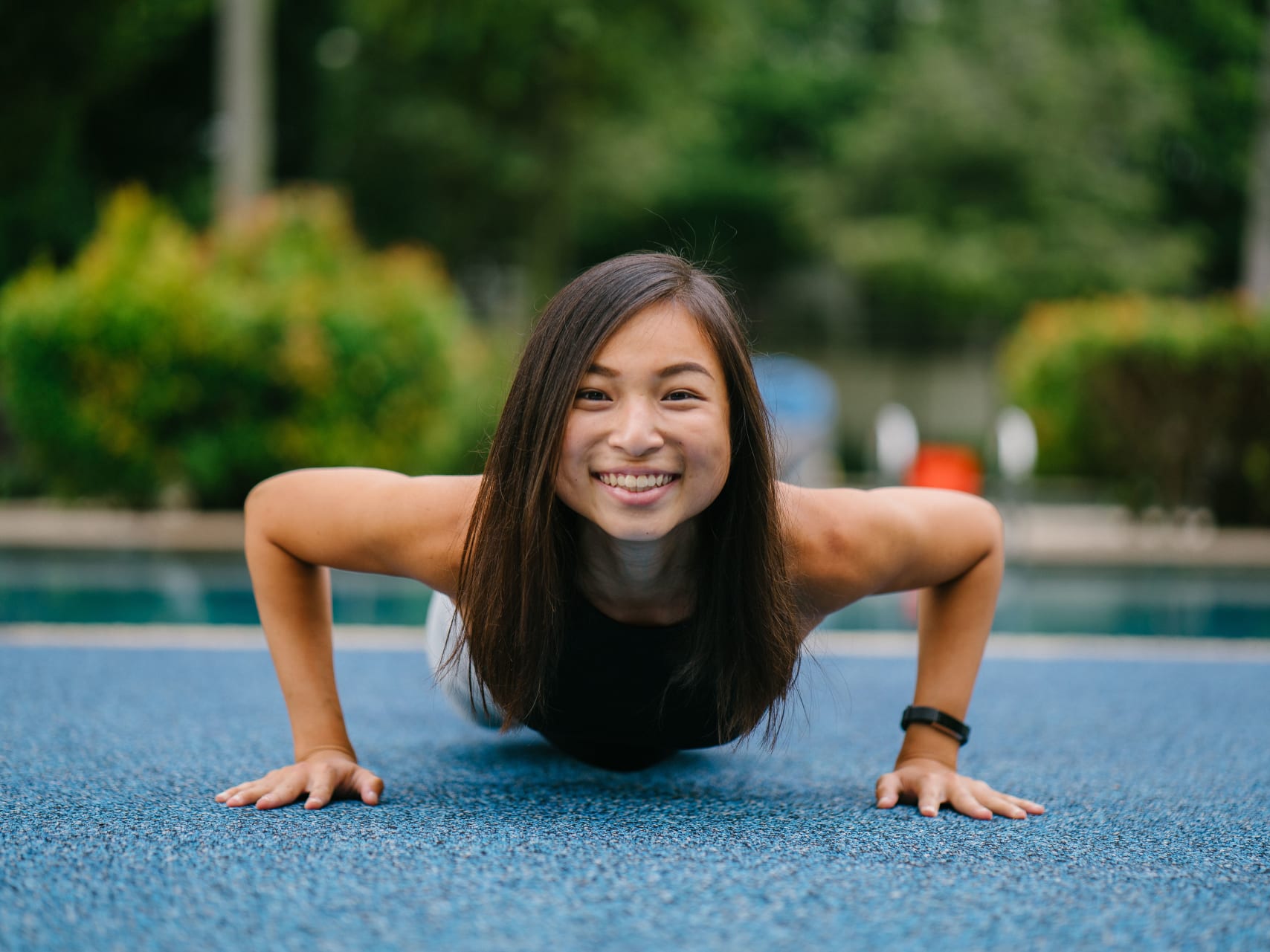 shutterstock_1101062303 Young woman doing push up