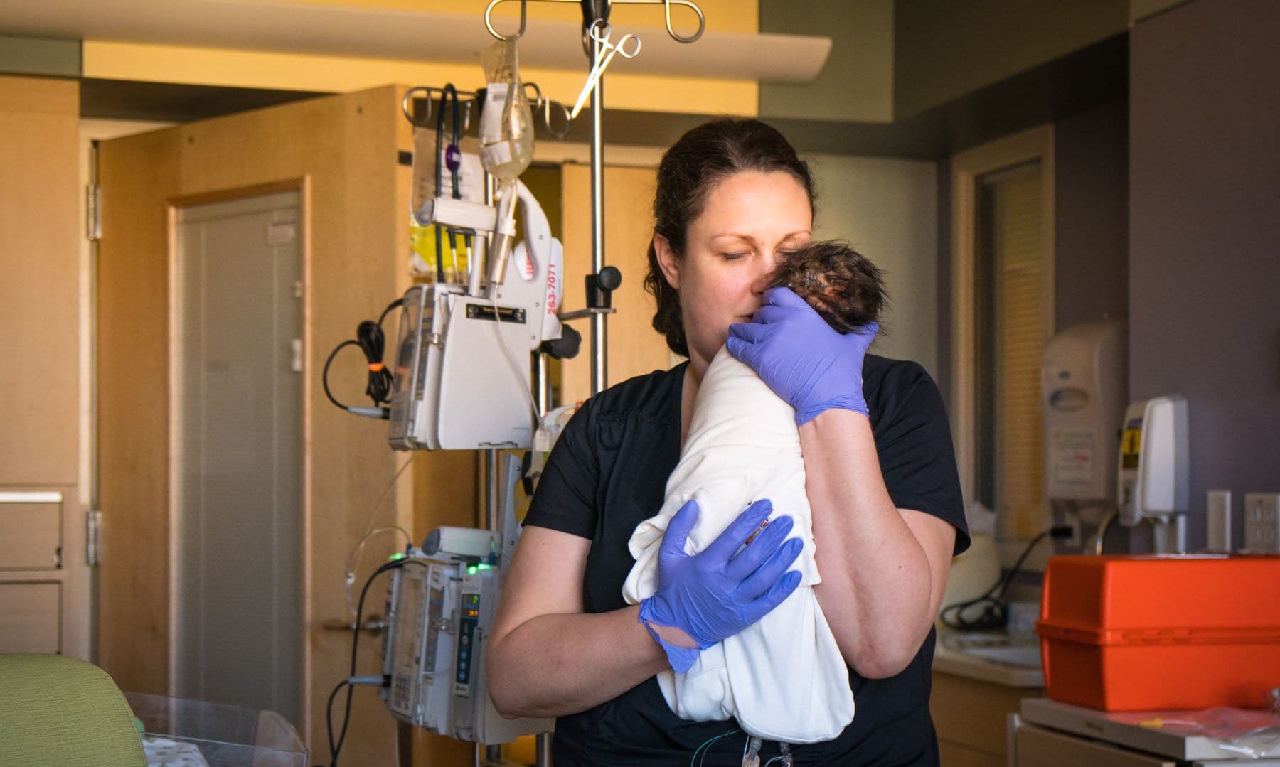 AFCH_nurse_holding_newborn_600 Nurse holding newborn