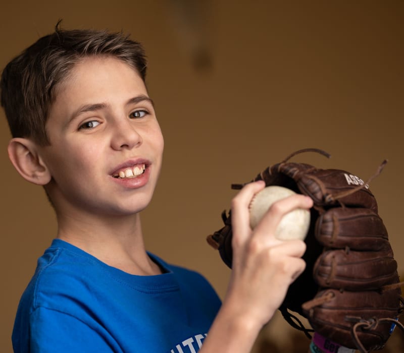 Will Andrews 471242-5199.jpg Boy smiling with baseball and baseball glove.