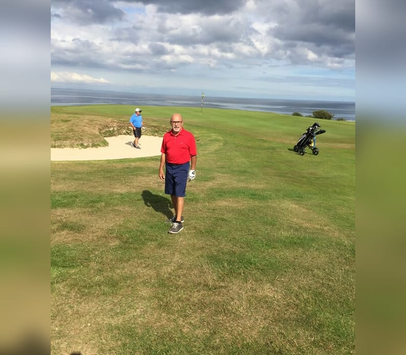 John DeSimone walking on a golf course