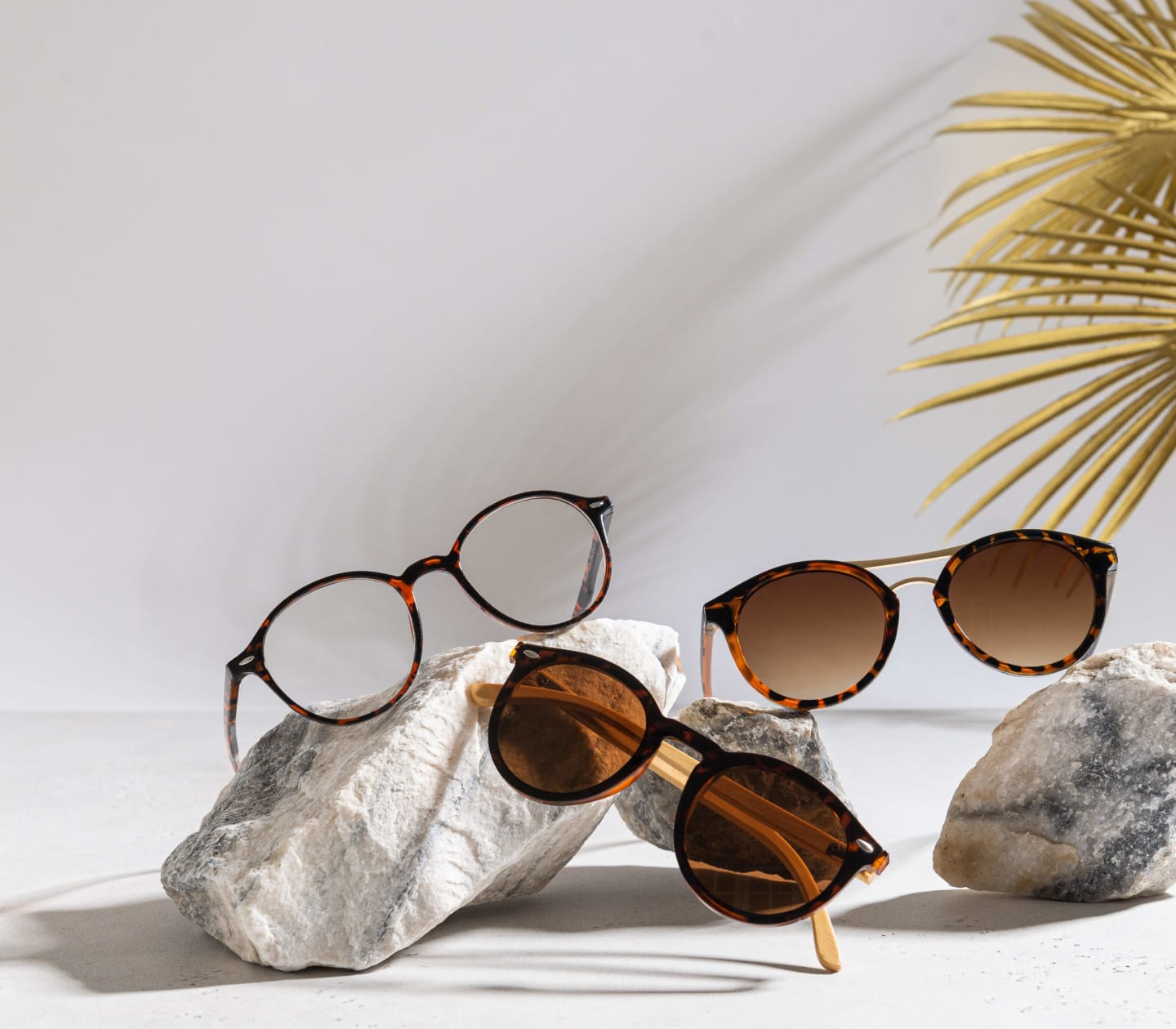 Three pairs of glasses displayed on large rocks