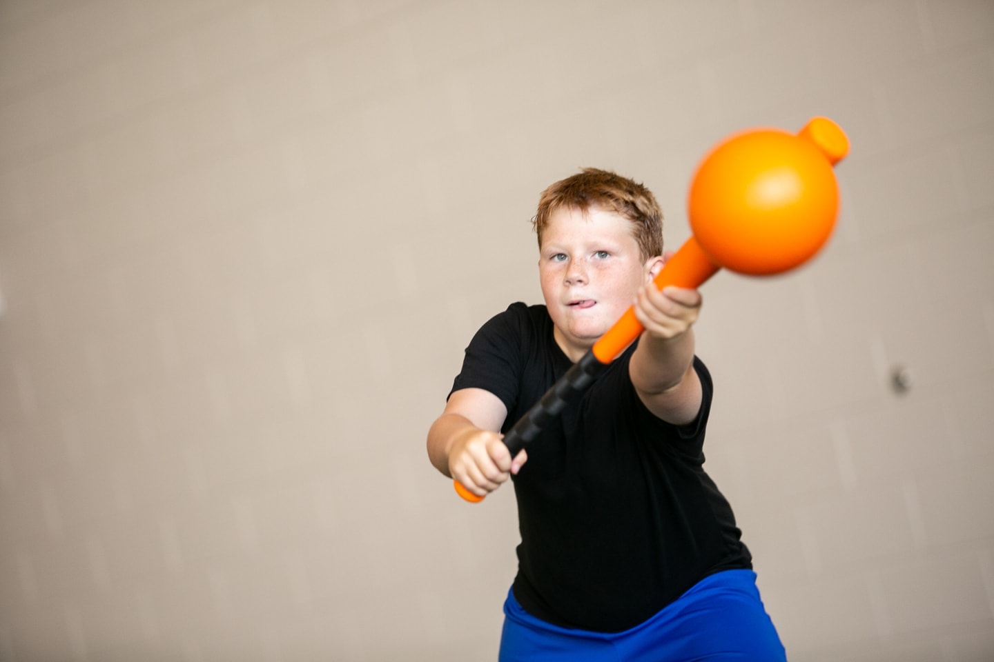 A child swinging a weighted stick