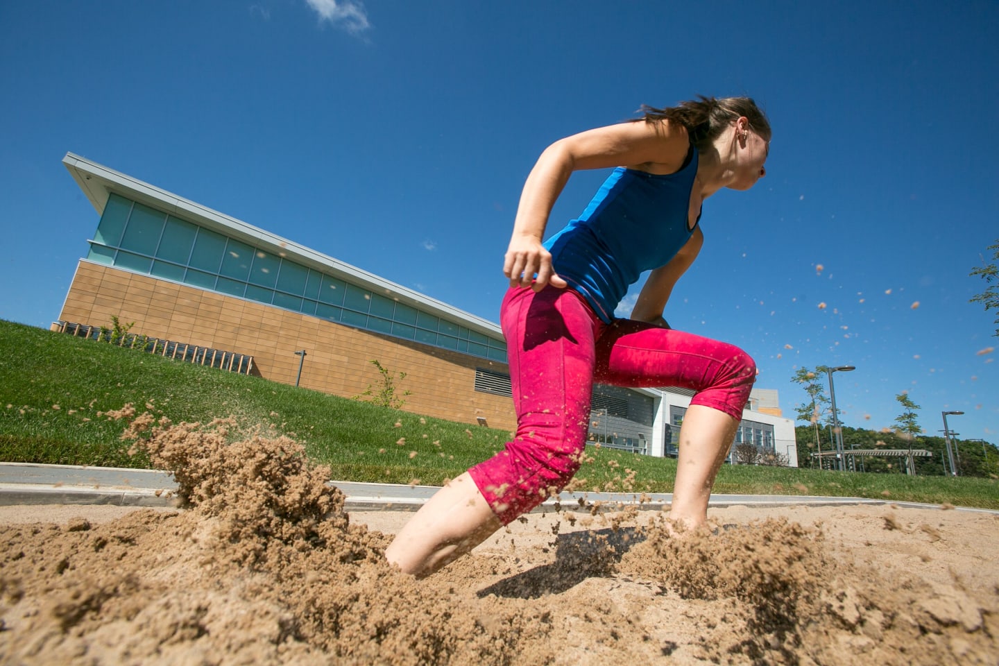 A person running in a sand volleyball court