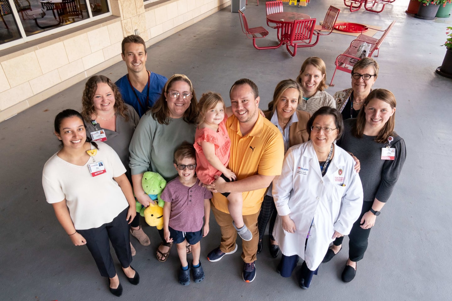 A young girl surrounded by her family and medical providers