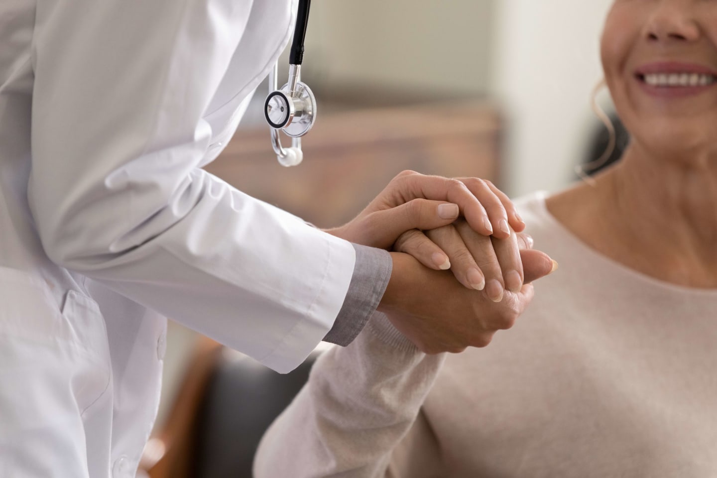 Provider holding the hand of a patient